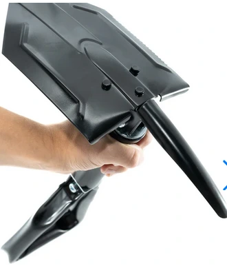 a hand holding the digger folding shovel.
